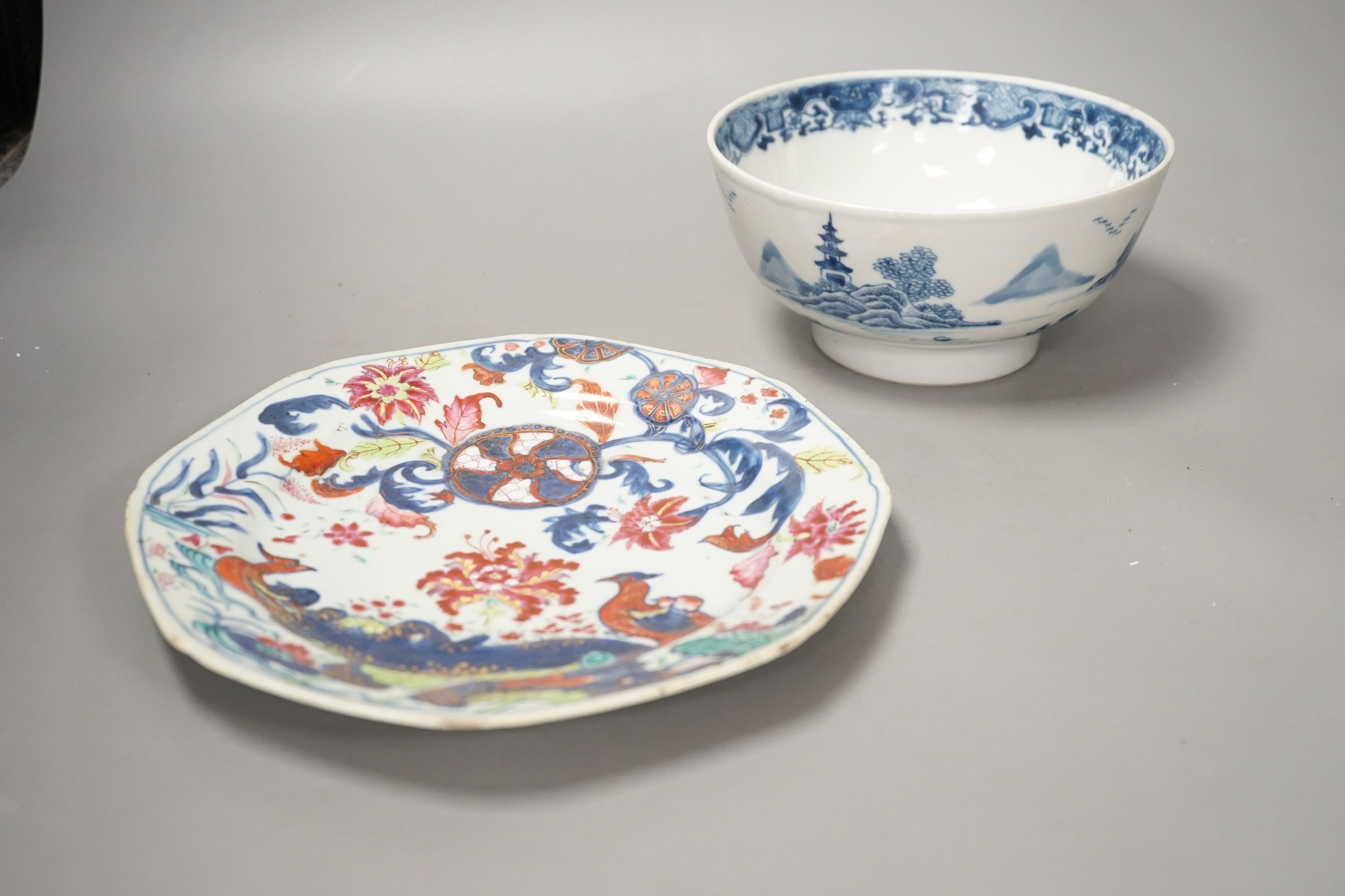 An 18th century Chinese famille rose ‘birds and lotus’ plate, and a Chinese blue and white ‘landscape’ bowl, 17.6cm